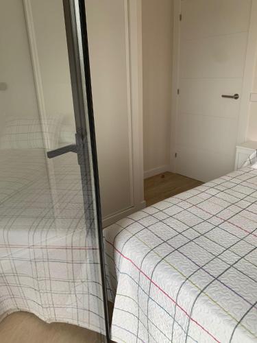 a bedroom with a bed with a glass wall at NUEVO Loylla Niembro a 500 m de la playa in Niembro