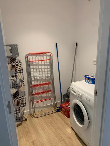 a laundry room with a washing machine and a washer at NUEVO Loylla Niembro a 500 m de la playa in Niembro