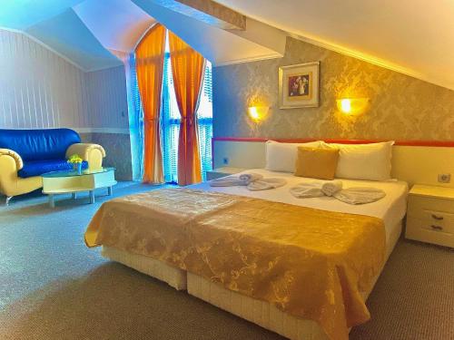 a bedroom with a king sized bed in a room at Boutique Hotel Royal in Nesebar