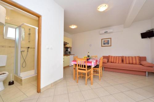 a living room with a table and a couch at Holiday home in Drage with sea views, balcony, air conditioning,WiFi 592-1 in Drage