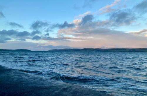 a view of the ocean with a cloudy sky at Waters Edge in Stranraer