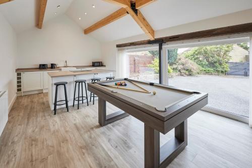 a kitchen with a pool table in a house at Host & Stay - The Hay Loft in Wakefield