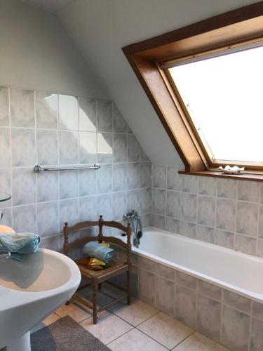 a bathroom with a bath tub and a sink at Peppino II 0202 - 3 bedrooms 6p - penthouse sunny terraces in Sint-Idesbald