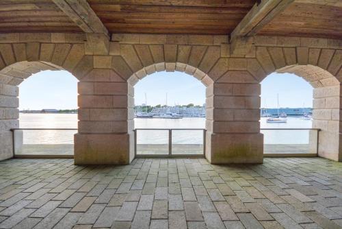 a view of the water from a building with three arches at RWY Suite58 Luxury 2 Bed Apartment at Royal William Yard in Plymouth