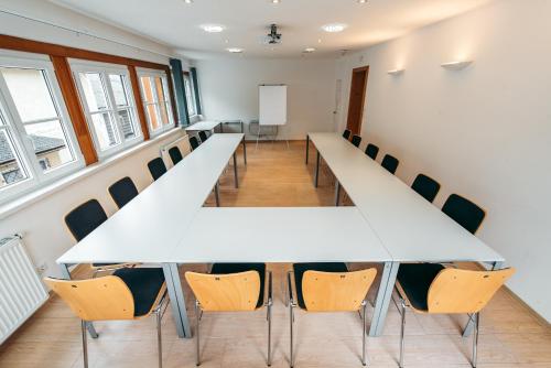 a conference room with a long table and chairs at Wander- und Wellnesshotel Kanzler in Bad Mitterndorf