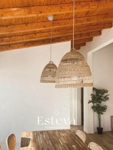 two pendant lights hanging from the ceiling in a dining room at Esteva CountryHouse in Rogil