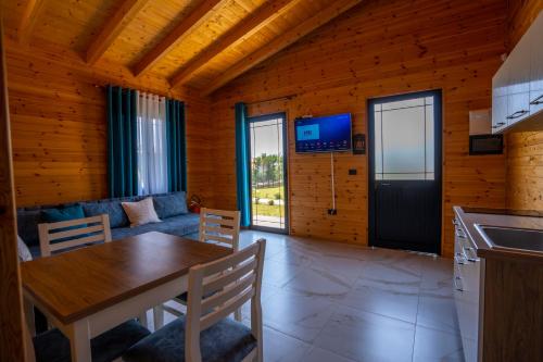 a kitchen and living room with a table and a couch at The Sea House Velipoje in Velipojë