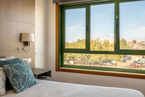a bedroom with a bed and a large window at Apartamento La orilla in Arrecife