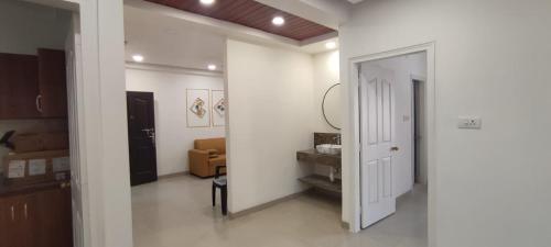 a hallway with a white door and a living room at B S Homes in Hyderabad
