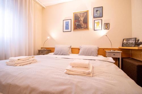 two beds in a room with towels on them at Rothornblick 19 in Arosa
