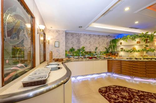 a large kitchen with sinks and a tub at Grand Anka Hotel in Istanbul
