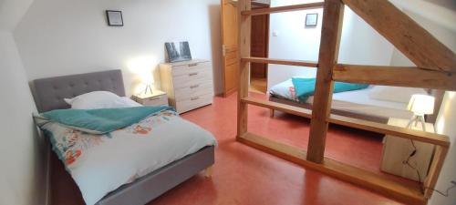 a bedroom with a bunk bed and a mirror at Le haut clocher in Fumay