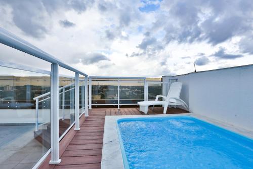 a balcony with a swimming pool on top of a building at MG Flats Hotel & Residence in Cuiabá