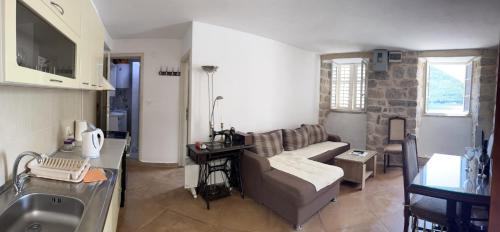 a living room with a couch and a sink at Apartman Dado in Perast