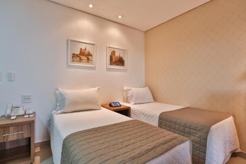 Ένα ή περισσότερα κρεβάτια σε δωμάτιο στο MG Flats & Residence