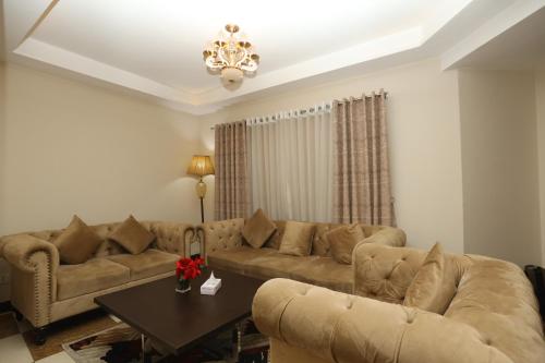 a living room with a couch and a table at Magnum Inn in Lahore