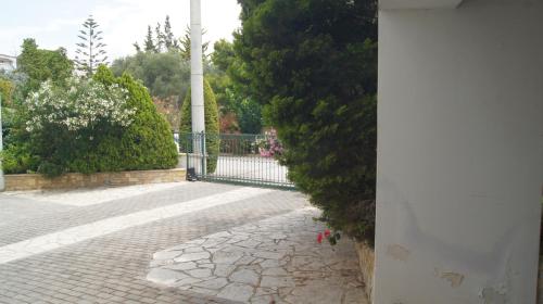 a stone walkway with a gate in a park at Electra in Saronida
