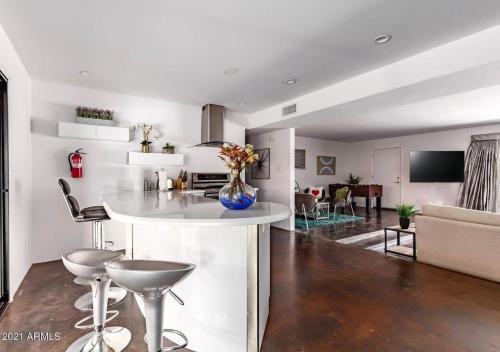 a kitchen and living room with a table and chairs at Designer 5 Bd Home, Fountain Pool, Spa, Game Patio in Phoenix