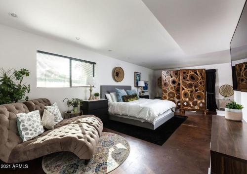 a living room with a bed and a couch at Designer 5 Bd Home, Fountain Pool, Spa, Game Patio in Phoenix