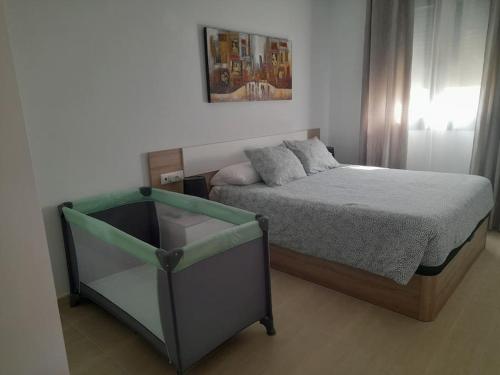 a bedroom with a bed and a glass table at Apartamento Isabel in Sant Carles de la Ràpita