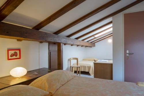 a bedroom with a bed and a kitchen in a room at Parkhotel Emmaus - Casa Rustico in Ascona