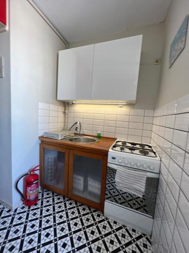 a kitchen with a sink and a stove at Do Gdyni in Gdynia