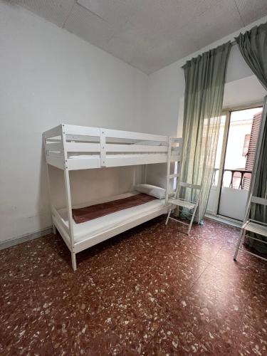 a bedroom with two bunk beds and a window at MAGENTA GUEST HOUSE in Rome