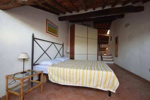 a bedroom with a bed and a side table at Mansarda tra Cielo e Mare in Scarlino