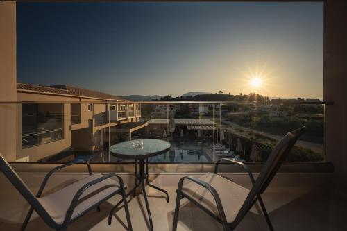 a balcony with a table and chairs and a view at Vice Hotel in Laganas