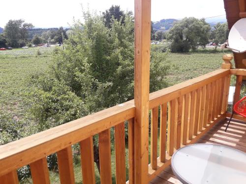 a balcony with a table and a view of a field at Hof Notburga - Erholung, Ruhe & Natur pur in Jakling
