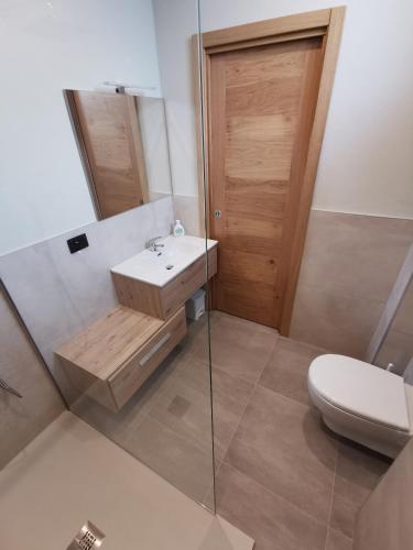 a bathroom with a toilet and a sink and a shower at La Torretta in Dronero