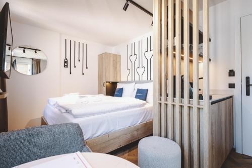a bedroom with a bed and a chair at The Gast House Zell am See in Zell am See