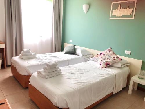 two beds in a room with blue walls at Sportland in Colle Val D'Elsa