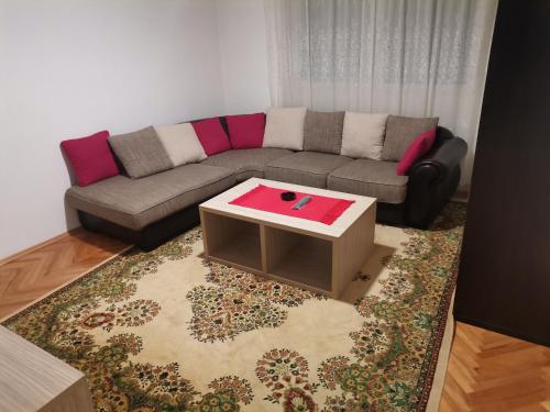 a living room with a couch and a coffee table at STAN na DAN PEX FREE PARKING in Vranje