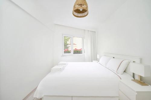 a white bedroom with a white bed and a window at Bright Modern New 1bed1bath Hidden Gem Bebek! #78 in Istanbul
