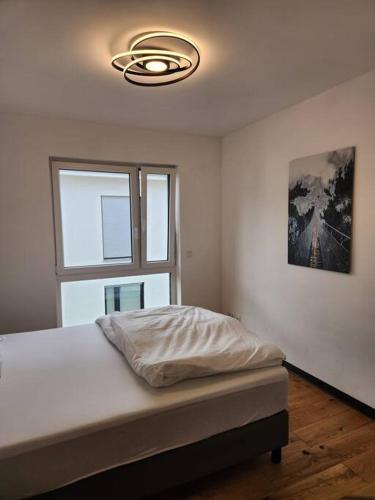 a bedroom with a bed and a large window at Ferienwohnung am Goitzschesee in Pouch