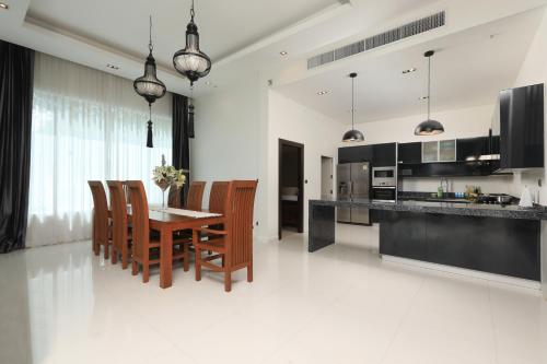 a kitchen and dining room with a table and chairs at Dolphin Villa in Patong Beach