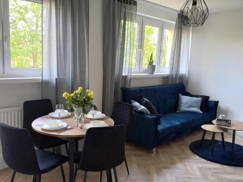 a living room with a blue couch and a table at katedrahouse in Wrocław