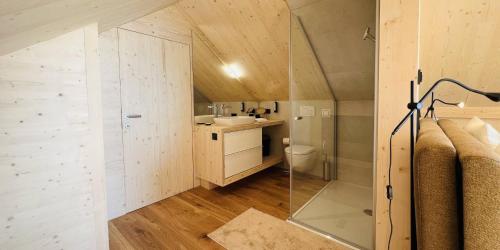a small bathroom with a sink and a toilet at Naturel Chalet am Faaker See in Faak am See
