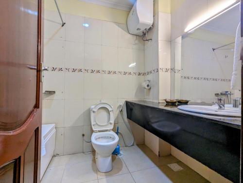 a bathroom with a toilet and a sink at Mvuli Hotels Arusha in Arusha