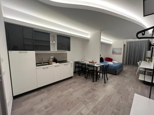 a kitchen and living room with a table and a couch at La Casba in Paola