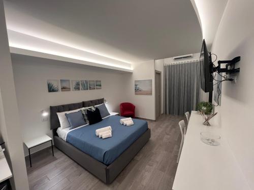 a bedroom with a bed and a table in it at La Casba in Paola