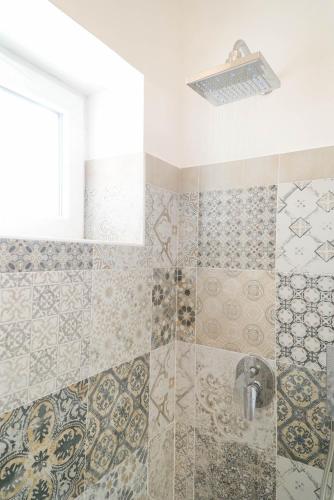 a bathroom with a shower with a sink at Ninfea Apartment Superior in Vico Equense