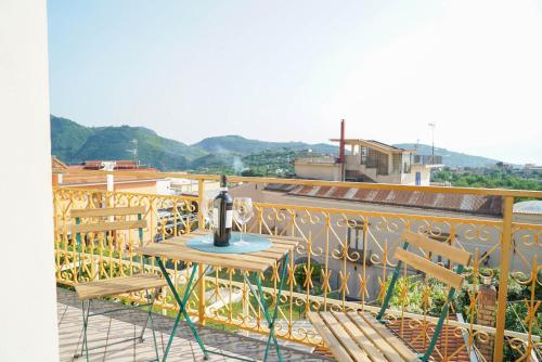 a table and chairs on a balcony with a view at Ninfea Apartment Superior in Vico Equense