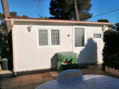 a small white shed with a green bag on it at SOUS LE SOLEIL DE PROVENCE in Le Castellet