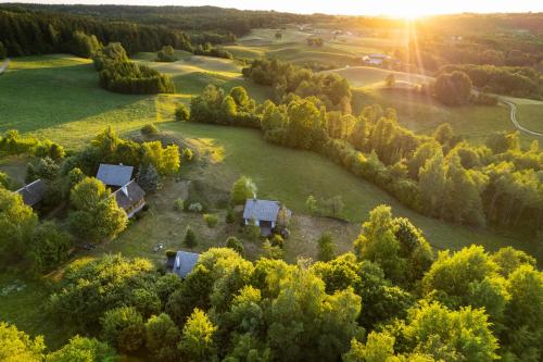 an aerial view of a house in a field with trees at Cisowe Wzgórze in Rowele