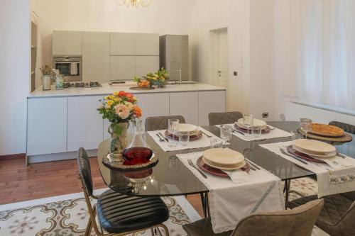 jadalnia ze stołem i krzesłami oraz kuchnia w obiekcie Fabiola exclusive apartment w mieście Grottaglie