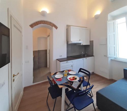 a kitchen and dining room with a table and chairs at Casa Brezza marina in Marina di Campo