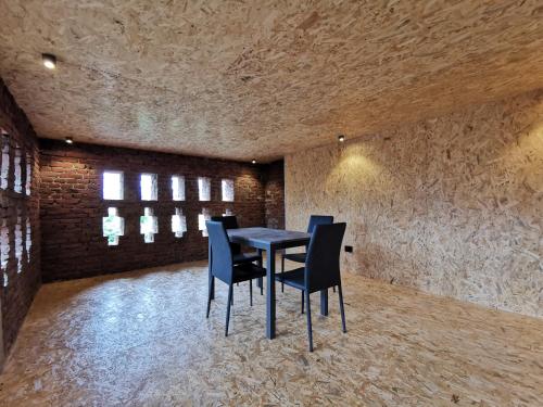 a dining room with a table and blue chairs at La Torretta in Dronero