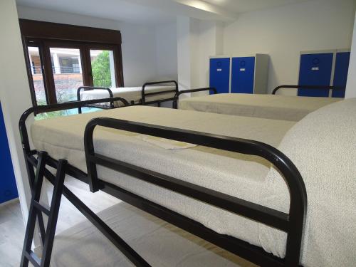 Ένα ή περισσότερα κρεβάτια σε δωμάτιο στο Albergue Roma